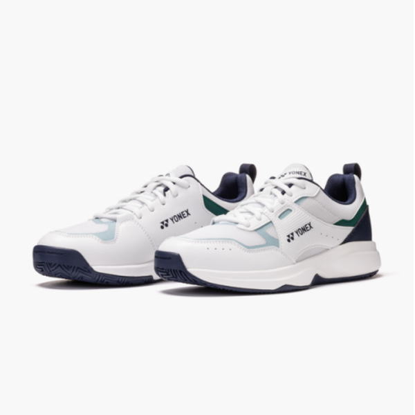 White Yonex tennis shoes with navy blue and teal accents, pair shown from side角 view.