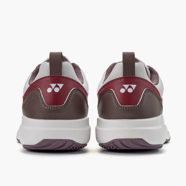 Back view of brown and burgundy athletic sneakers with white midsoles on a white background.