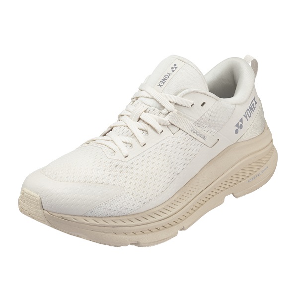 White Yonex athletic shoe with a beige cushioned sole and breathable mesh upper, lace-up style.