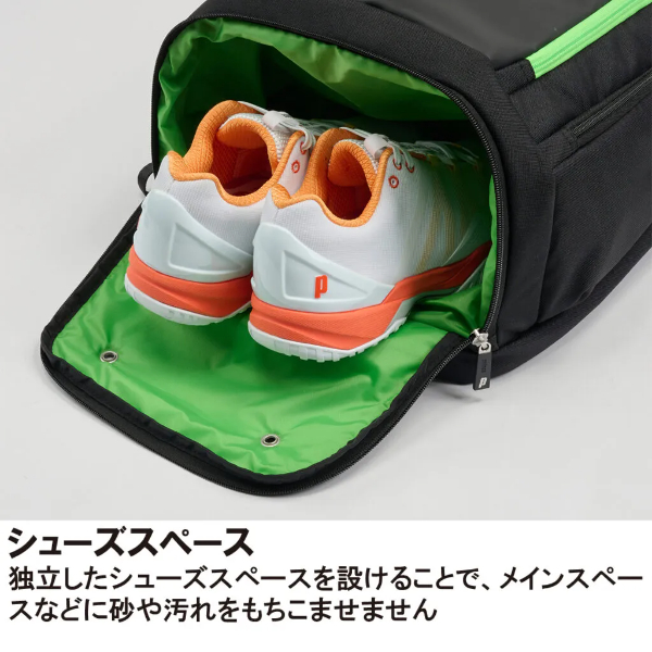 Backpack with a separate shoe compartment holding white and orange running shoes inside a green-lined interior.