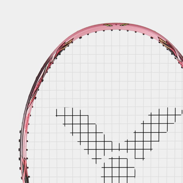 Close-up of a pink tennis racket head with white strings and a black V-shaped string pattern
