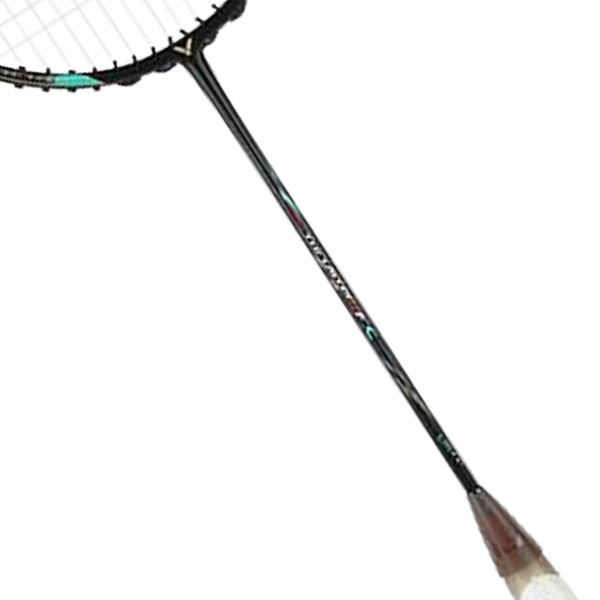 Diagonally angled badminton racket with strings visible and a shuttlecock near the handle side