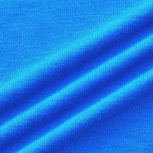 Close-up of bright royal blue fabric with diagonal folds and a textured weave.