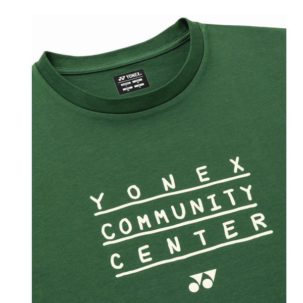 Green Yonex T-shirt with white 'YONEX COMMUNITY CENTER' text laid out in three lines and Yonex logo at the bottom.