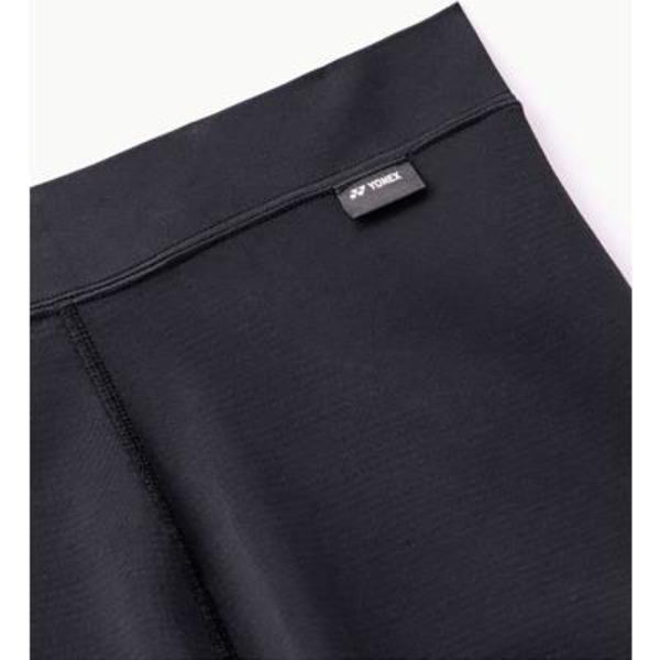 Close-up of a dark fabric waistband with a small brand tag attached.