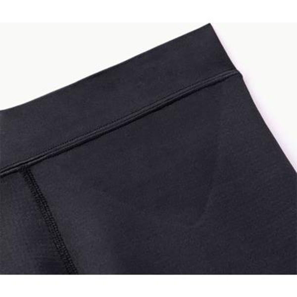 Close-up of black athletic leggings waistband with flatlock stitching.