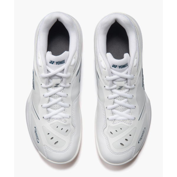 Top-down view of a pair of white Yonex badminton shoes with laces tied, shown side by side.