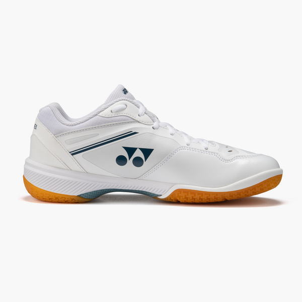 White athletic shoe with a blue Yonex logo, light gray accents, and an orange rubber outsole, shown in profile.