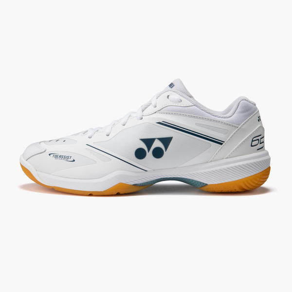 White Yonex court shoe seen from side with blue logo, white upper, and orange outsole; athletic sneaker design.