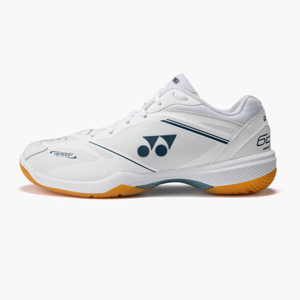 White Yonex tennis sneaker with blue accents and orange outsole, shown in side view