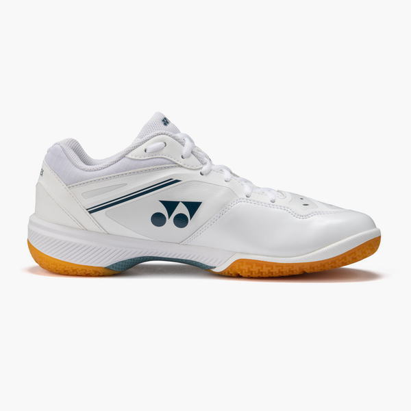 White athletic shoe with a dark blue Yonex logo, side view, orange outsole, and light blue accents.