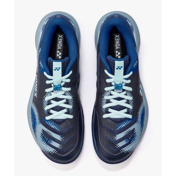 Top-down view of blue Yonex athletic shoes with white laces.