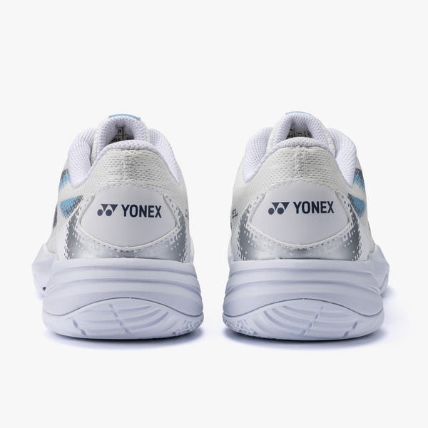 Rear view of white and silver Yonex running shoes with blue accents and cushioned heels.
