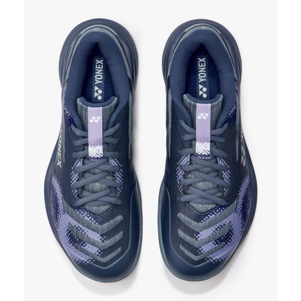 Pair of navy Yonex athletic sneakers with lavender laces, viewed from above.