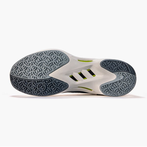 Bottom view of a white and gray athletic shoe sole with textured tread and lime-green accents