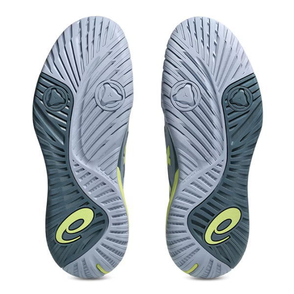 Pair of gray and dark teal athletic shoe soles with lime-green logo marks on the heel and tread pattern visible on both shoes