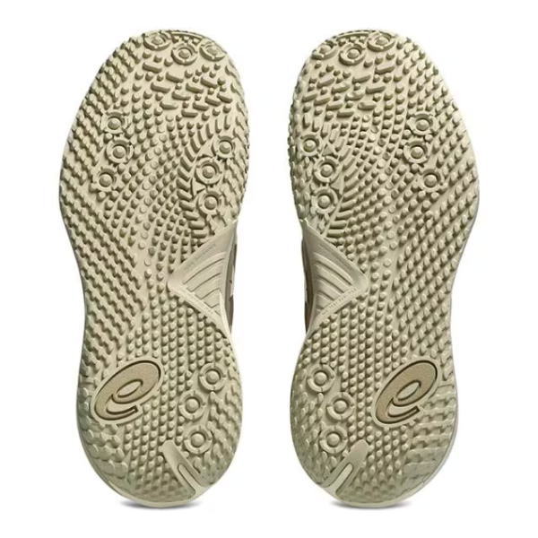 Bottom view of a pair of beige athletic sandals, showing textured rubber soles with circular studs and brand logos.