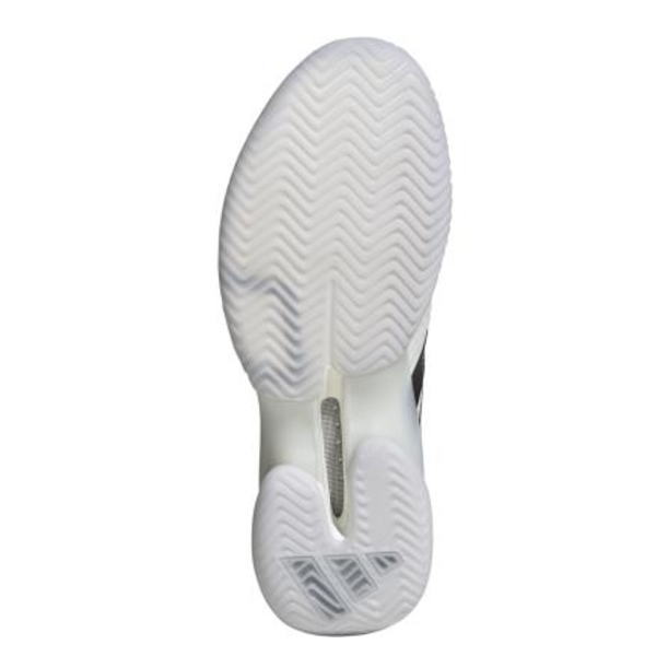 Bottom view of a sneaker sole with white herringbone tread and a cutout midsole, showing a small triangular logo near the heel area.