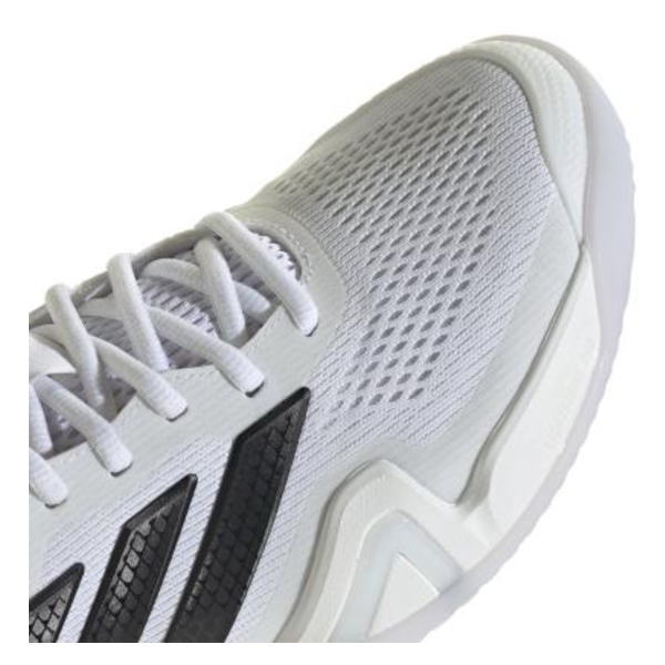 Close-up of a white athletic sneaker's upper and midsole, showing mesh material, white laces, and black side stripes.