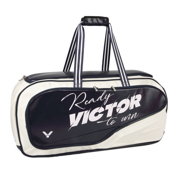 White and navy sport duffel bag with striped handles and large diagonal text reading 'Ready VICTOR to win' on the side panel.