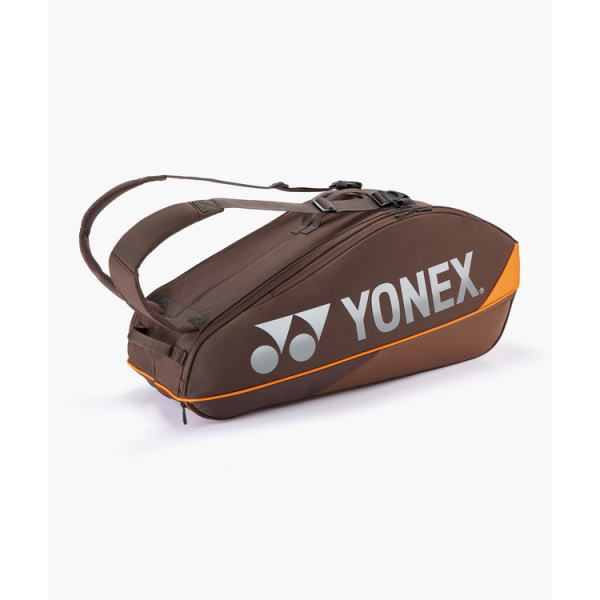 Brown Yonex racket bag with orange piping, carrying strap, and dual zippers, designed to hold racquets and gear.