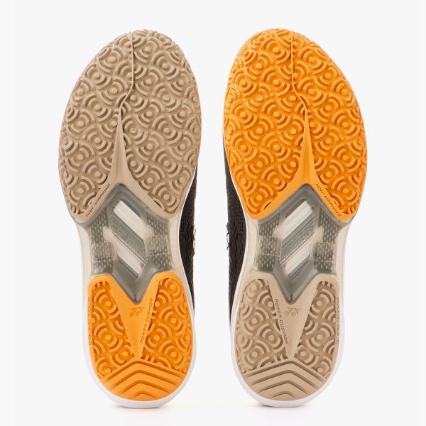 Pair of running shoes shown from the sole, left in beige and right in orange, with textured tread and midfoot cushioning.