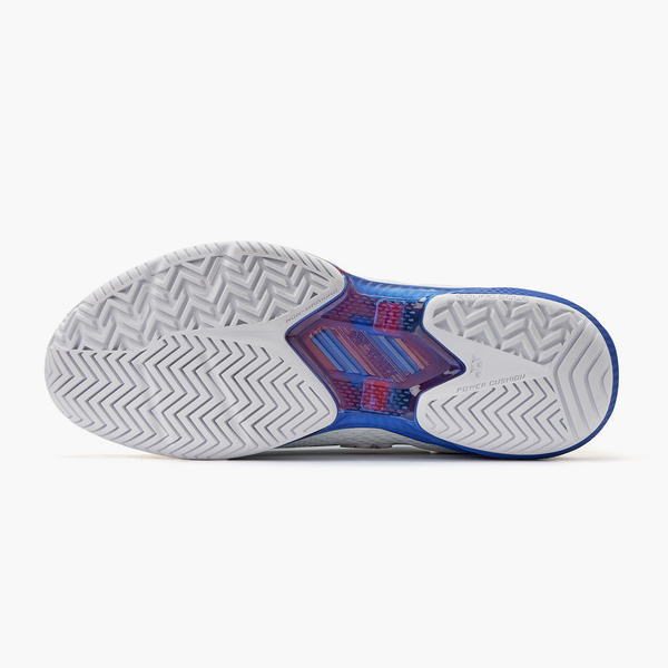 Bottom view of a blue athletic shoe showing white outsole with chevron/herringbone tread and blue/red midsole accents.
