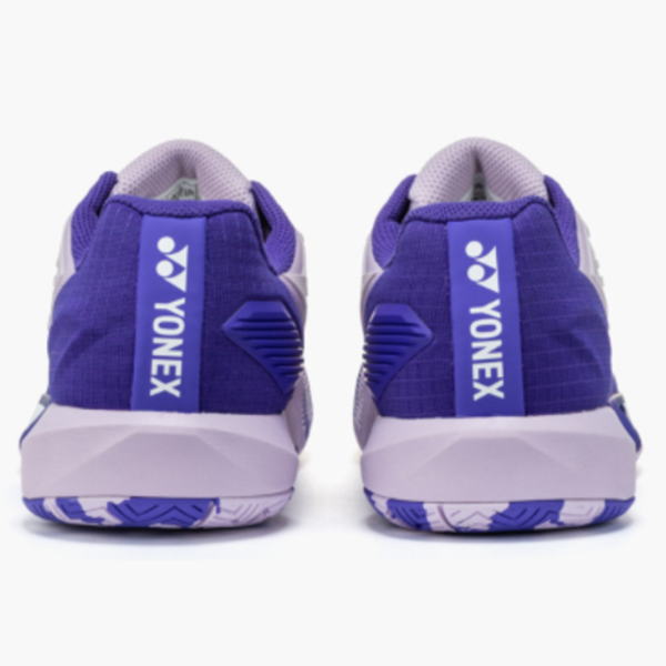 Pair of purple Yonex athletic shoes shown from the back with white midsoles and brand tabs on the heels.