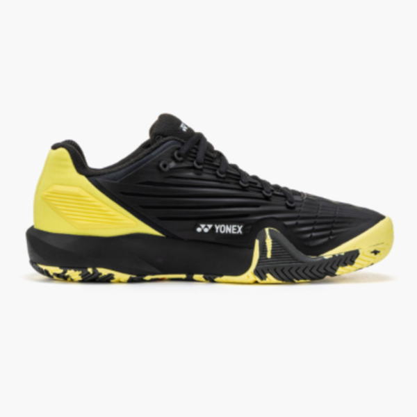 Yonex black and yellow athletic shoe with a yellow heel and sole on a white background.